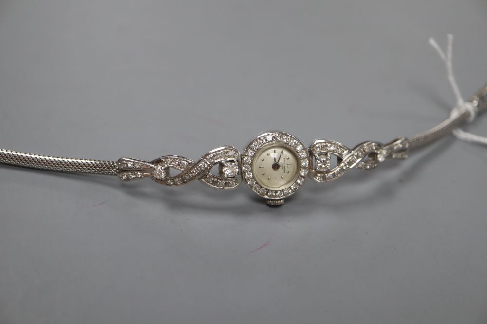 A ladys mid 20th century 585 white metal and diamond set Baume & Mercier manual wind cocktail watch, approx. 18.5cm.